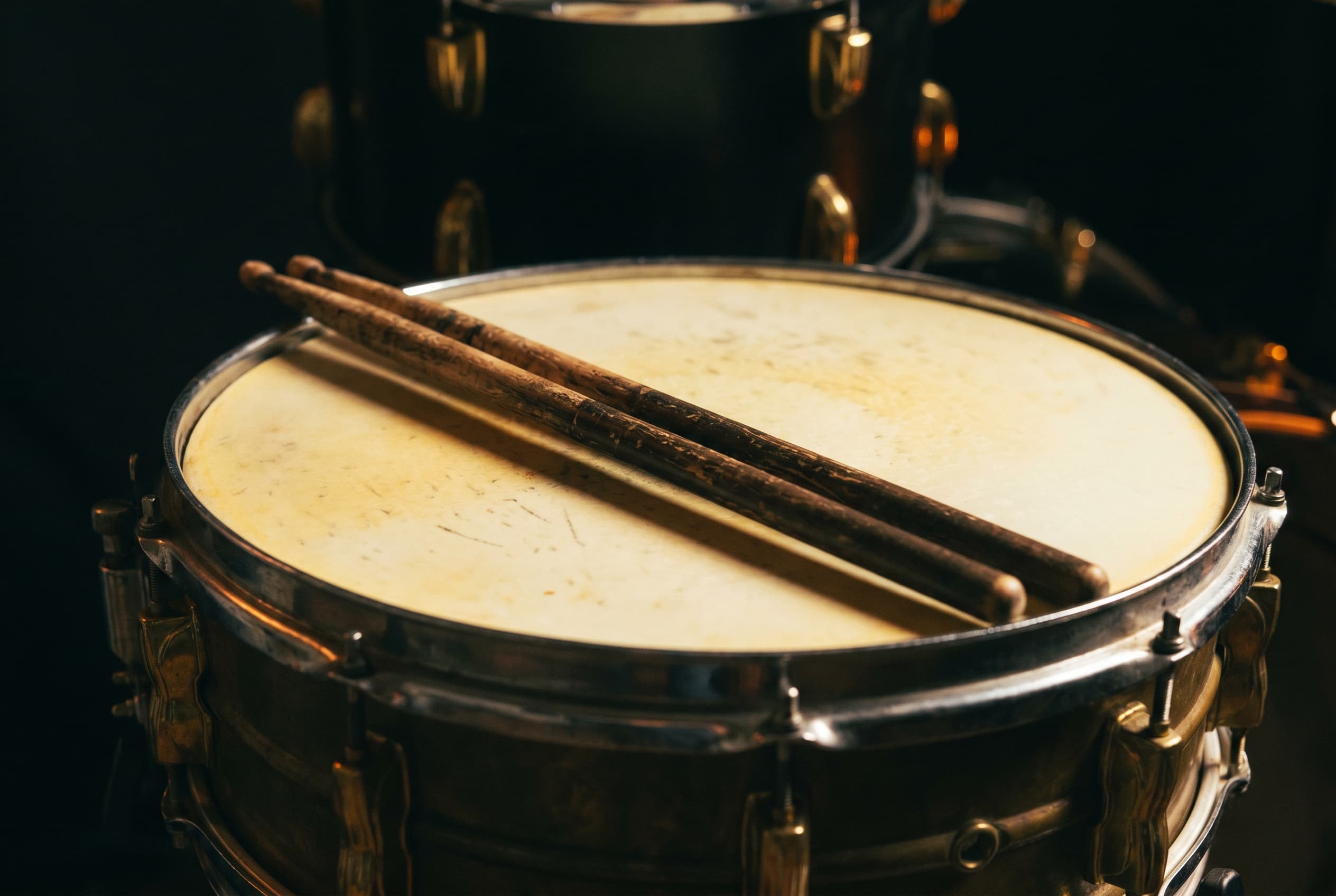 Drumsticks resting on a snare drum